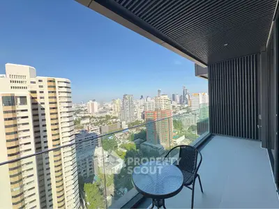 Stunning cityscape view from modern high-rise balcony with sleek glass railing.