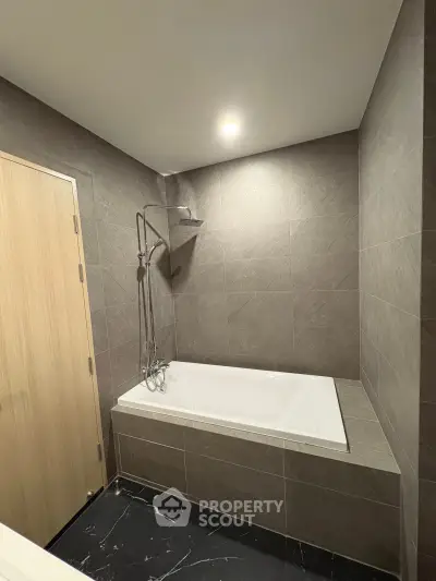 Modern bathroom with sleek bathtub and elegant tile design