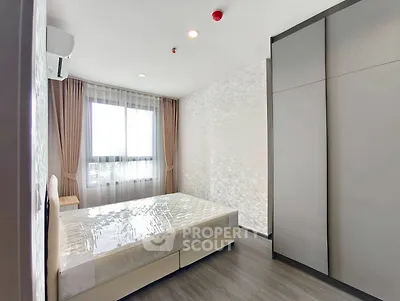 Modern bedroom with large window and sleek wardrobe design