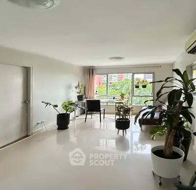 Spacious living room with lush greenery view and modern decor