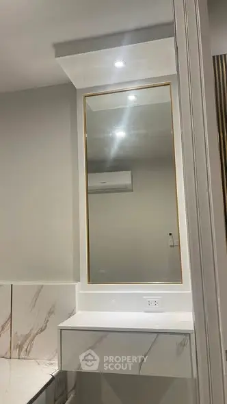 Modern bathroom with elegant marble accents and sleek mirror design