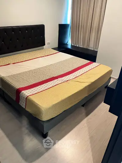 Cozy bedroom with modern bed and stylish decor, perfect for restful nights.