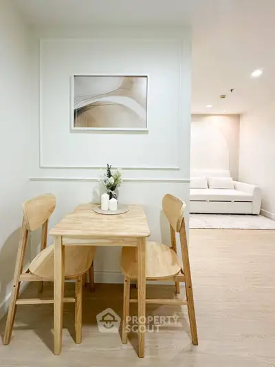 Cozy dining area with wooden table and chairs in modern apartment