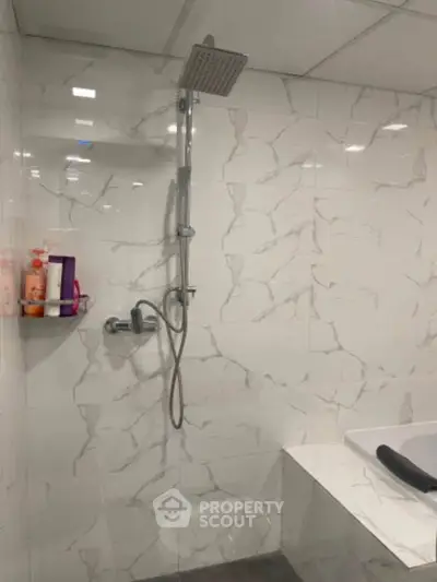 Modern bathroom with marble tiles and sleek shower design