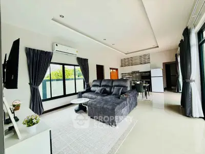 Spacious modern living room with open kitchen and large windows
