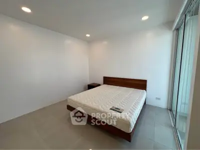 Spacious minimalist bedroom with large windows and modern lighting.