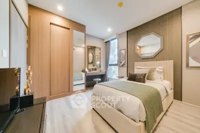 Elegant bedroom with modern decor and ample natural light