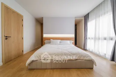 Spacious modern bedroom with natural light and minimalist design