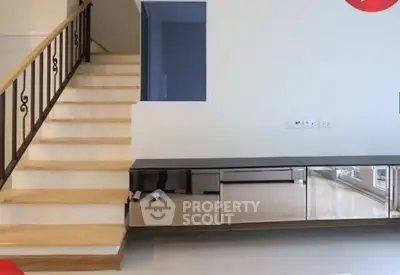 Modern interior with sleek staircase and mirrored cabinet in a stylish home
