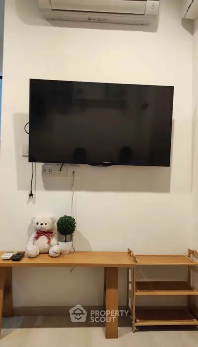 Cozy living room with wall-mounted TV and stylish decor