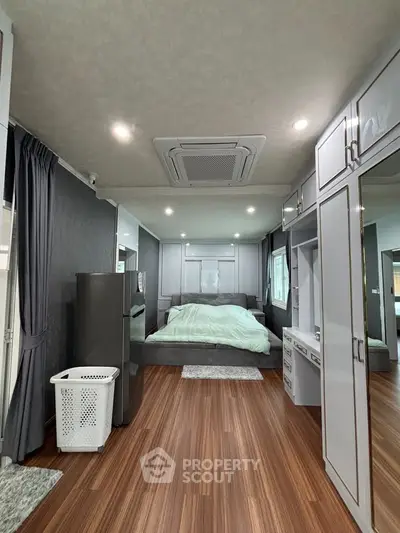 Spacious modern bedroom with elegant decor and ample storage space.