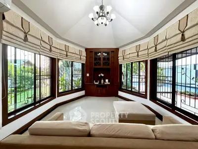 Spacious living room with large windows and elegant furnishings