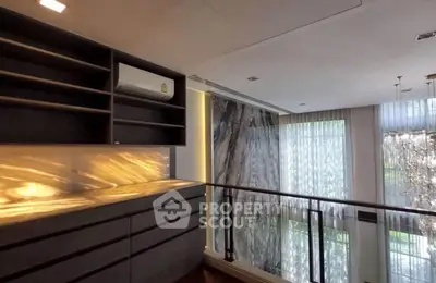 Luxurious modern interior with elegant lighting and large windows in a stylish living space.