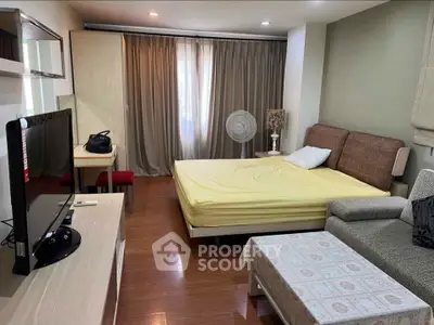 Cozy bedroom with modern furnishings and natural light, ideal for comfortable living.