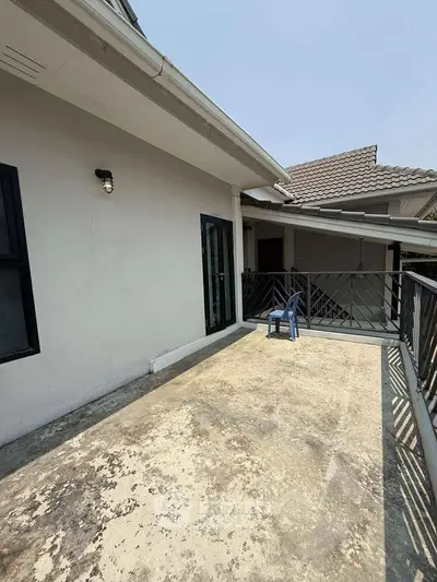 Spacious balcony with railing and outdoor seating in a modern residential property.