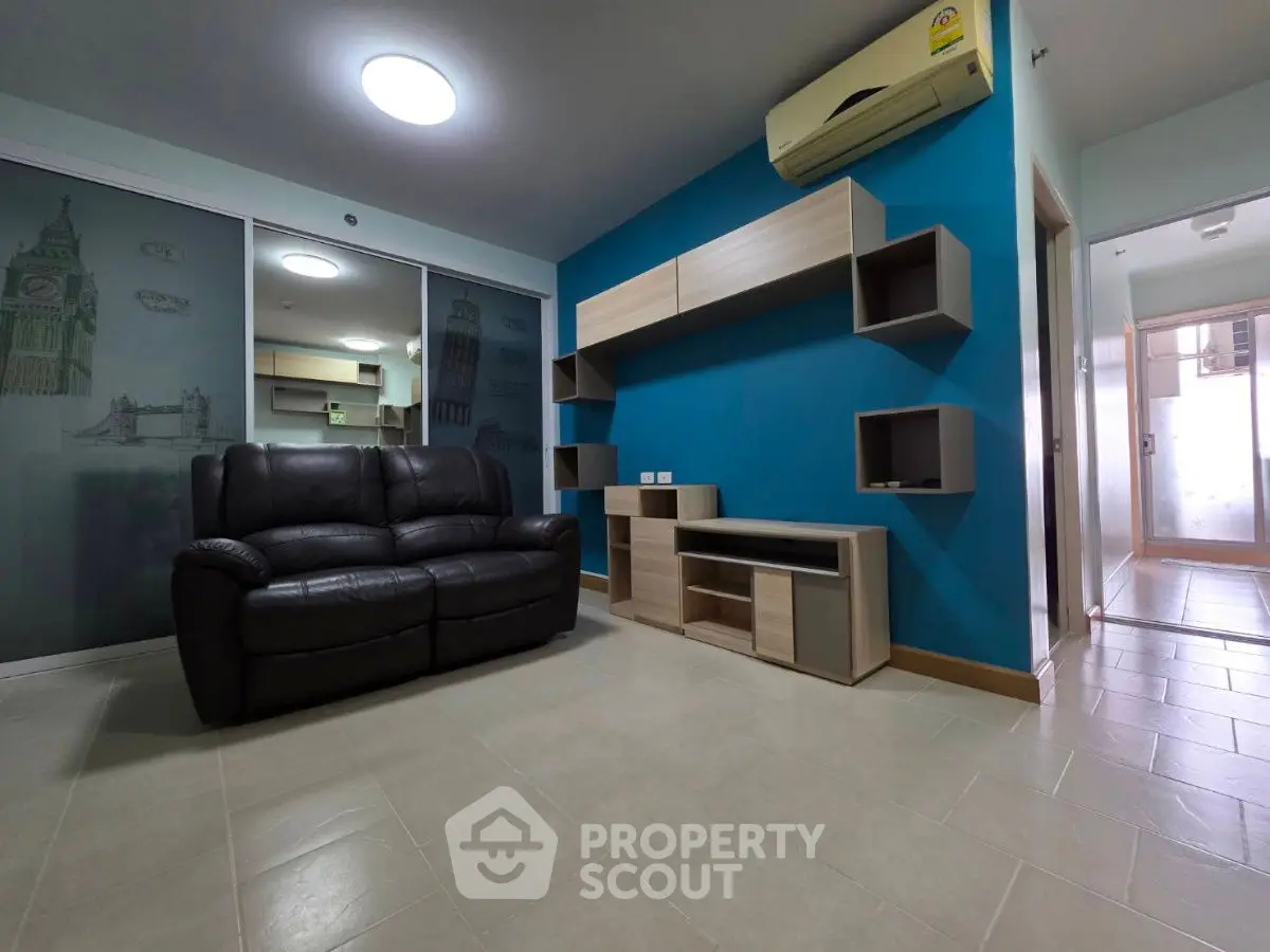 Modern living room with sleek furniture and vibrant blue accent wall