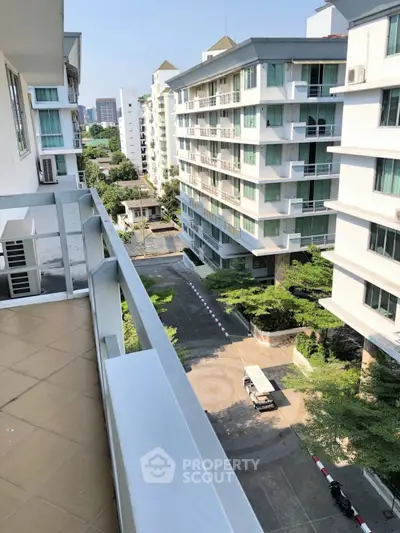 Spacious balcony with city view in modern apartment complex
