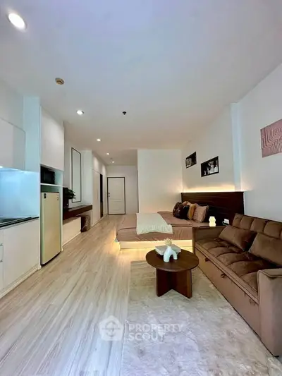 Spacious modern living room with cozy seating and stylish decor in a contemporary apartment.