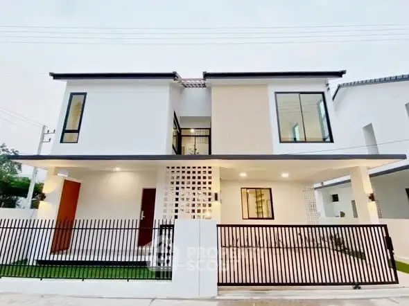 Modern two-story house with sleek design and spacious balcony, featuring large windows and a gated entrance.