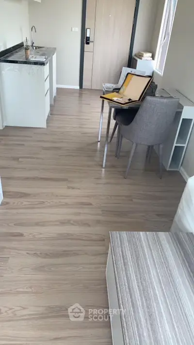Modern studio apartment with sleek kitchen and cozy dining area