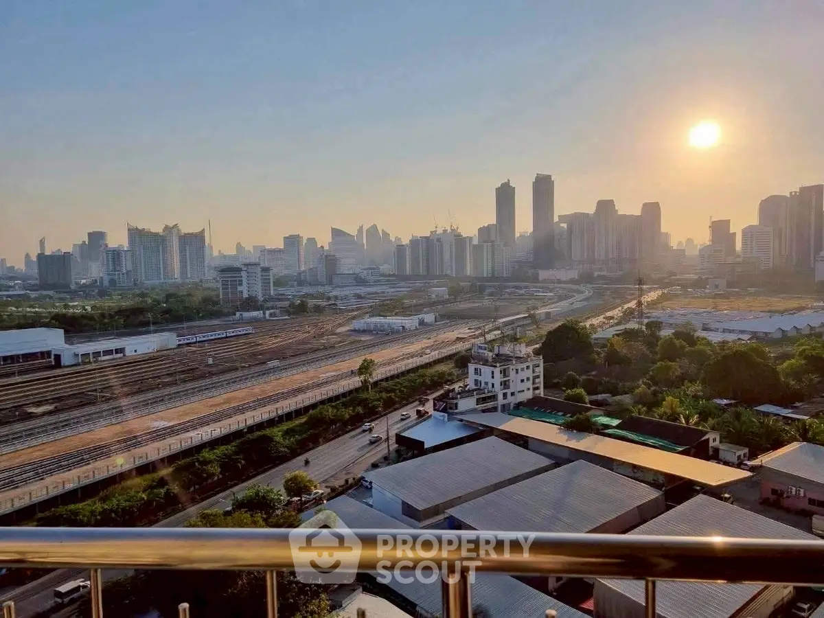 Stunning cityscape view from a high-rise balcony at sunset, showcasing urban skyline.