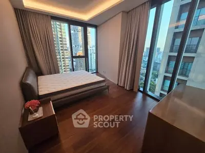 Luxurious bedroom with stunning city view and elegant wooden flooring