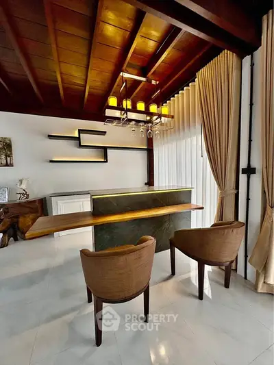 Elegant modern living room with stylish lighting and wooden ceiling accents.