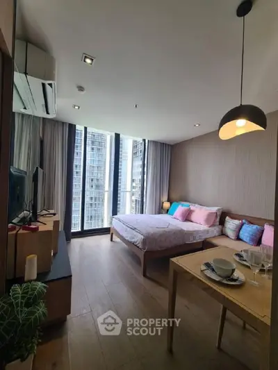 Modern bedroom with city view, featuring stylish decor and natural light.