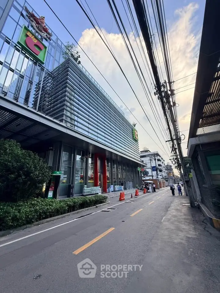 Modern commercial building exterior with glass facade and street view