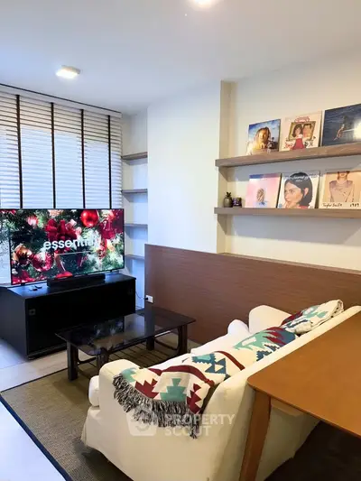 Cozy living room with modern decor and entertainment setup, perfect for relaxation.