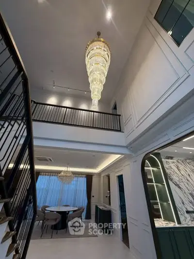 Luxurious modern interior with grand chandelier and elegant dining area