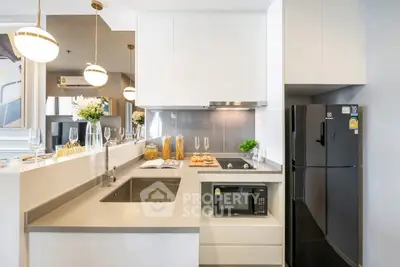 Modern kitchen with sleek design, featuring built-in appliances and stylish lighting.