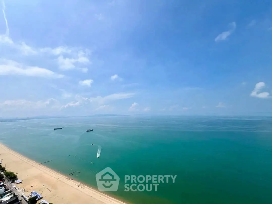 Stunning beachfront view with clear blue skies and serene ocean waters.