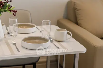 Modern dining setup with elegant tableware in a cozy living room setting.