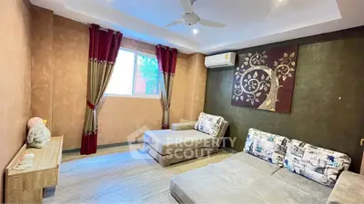 Spacious living room with modern decor and large windows for natural light.
