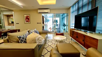 Luxurious living room with modern decor, large TV, and stylish furniture in a contemporary apartment.