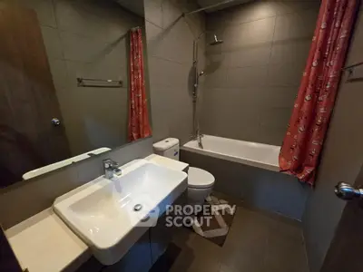 Modern bathroom with sleek fixtures and bathtub in contemporary apartment.