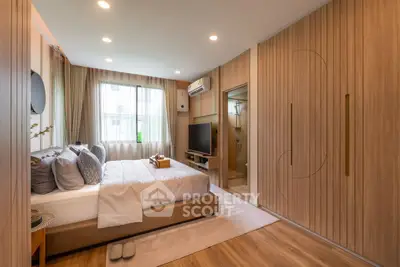 Luxurious bedroom with modern design and ensuite bathroom, featuring elegant wood paneling and ambient lighting.