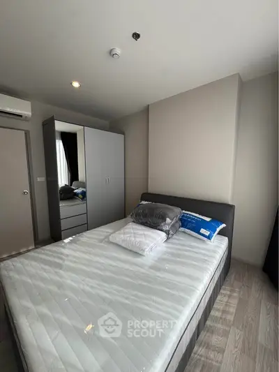 Modern bedroom with sleek design, featuring a comfortable bed and stylish wardrobe, perfect for urban living.