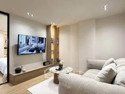 Modern living room with cozy sofa and wall-mounted TV in elegant apartment.