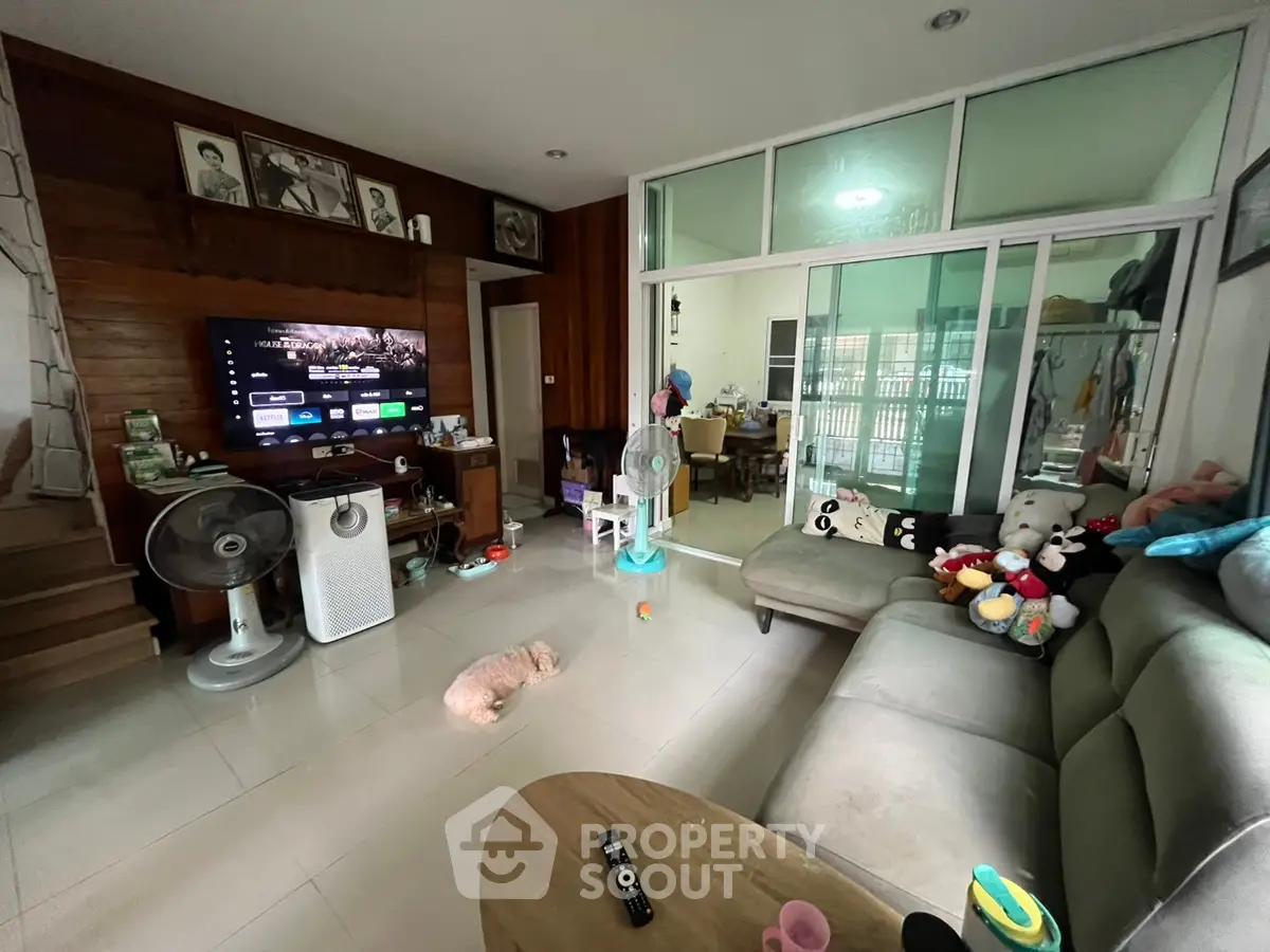 Spacious living room with modern decor and cozy seating area, perfect for family gatherings.