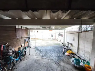 Spacious garage with ample storage and natural light, perfect for vehicles or workshop setup.
