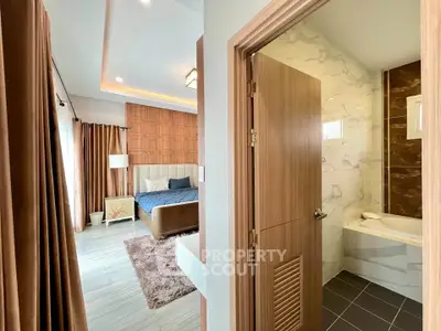 Luxurious bedroom with ensuite bathroom featuring modern design and elegant decor.
