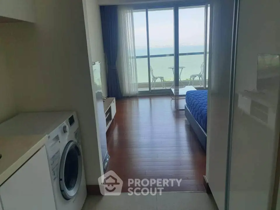 Modern bedroom with ocean view and in-unit washing machine