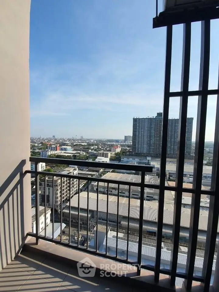 Stunning cityscape view from a high-rise balcony with modern railing design.