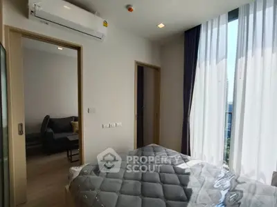 Modern bedroom with large windows and air conditioning in a stylish apartment