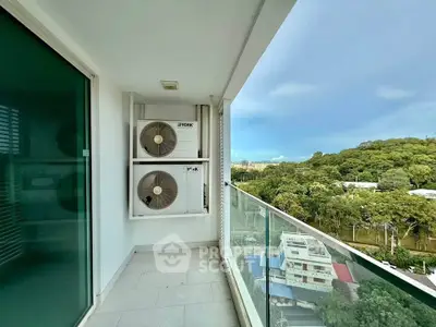 Spacious balcony with scenic view and air conditioning units in modern apartment.