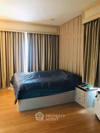 Spacious bedroom with elegant curtains and modern decor