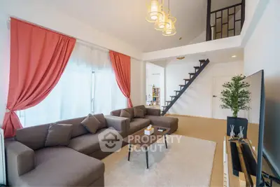 Spacious modern living room with high ceiling and stylish decor