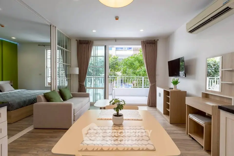 Modern open-plan living room with balcony view and stylish furnishings